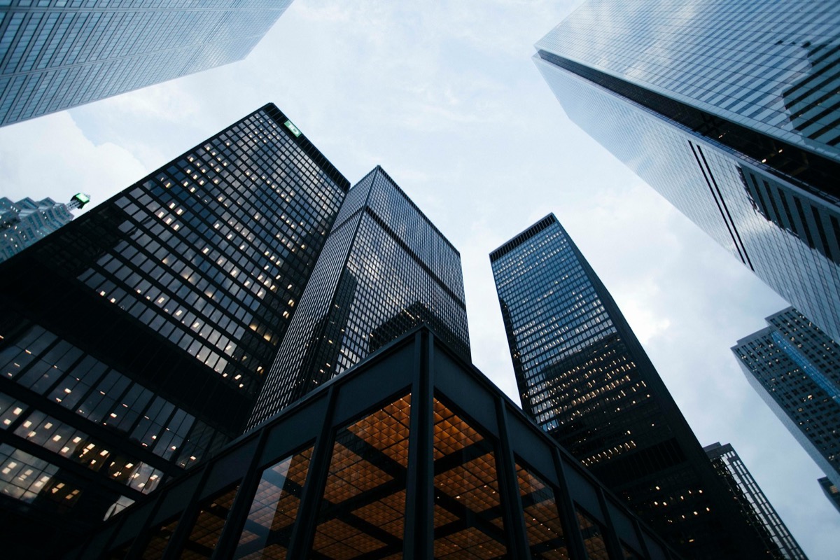 Office towers in a financial district, seen looking straight up from street level.